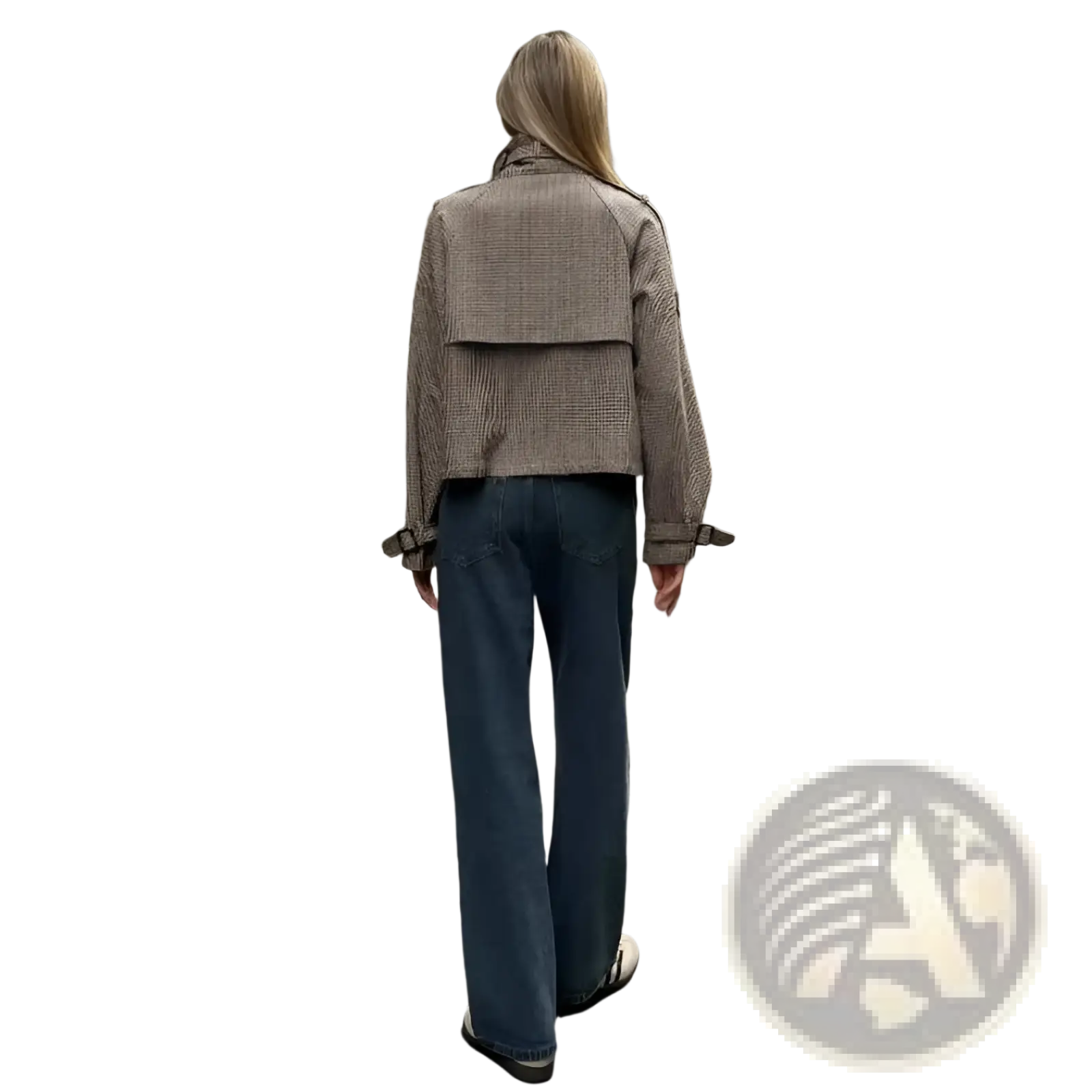 A woman wearing a beige and black houndstooth patterned relaxed fit double breasted jacket
