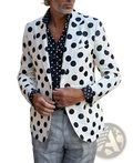 A man wearing a houndstooth slim fit suit jacket in white with black polka dots paired with gray plaid trousers