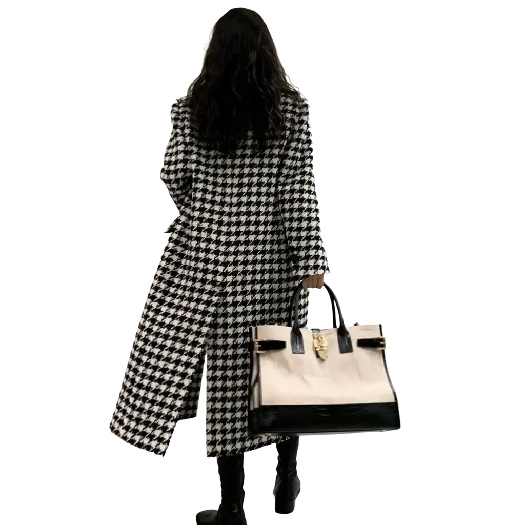 Cream and black two-tone handbag with glossy patent leather base and gold hardware paired with houndstooth wool coat
