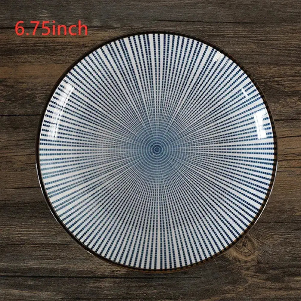 A minimalist Japanese ceramic 6.75-inch round plate with white surface and blue radial dot patterns and dark brown rim