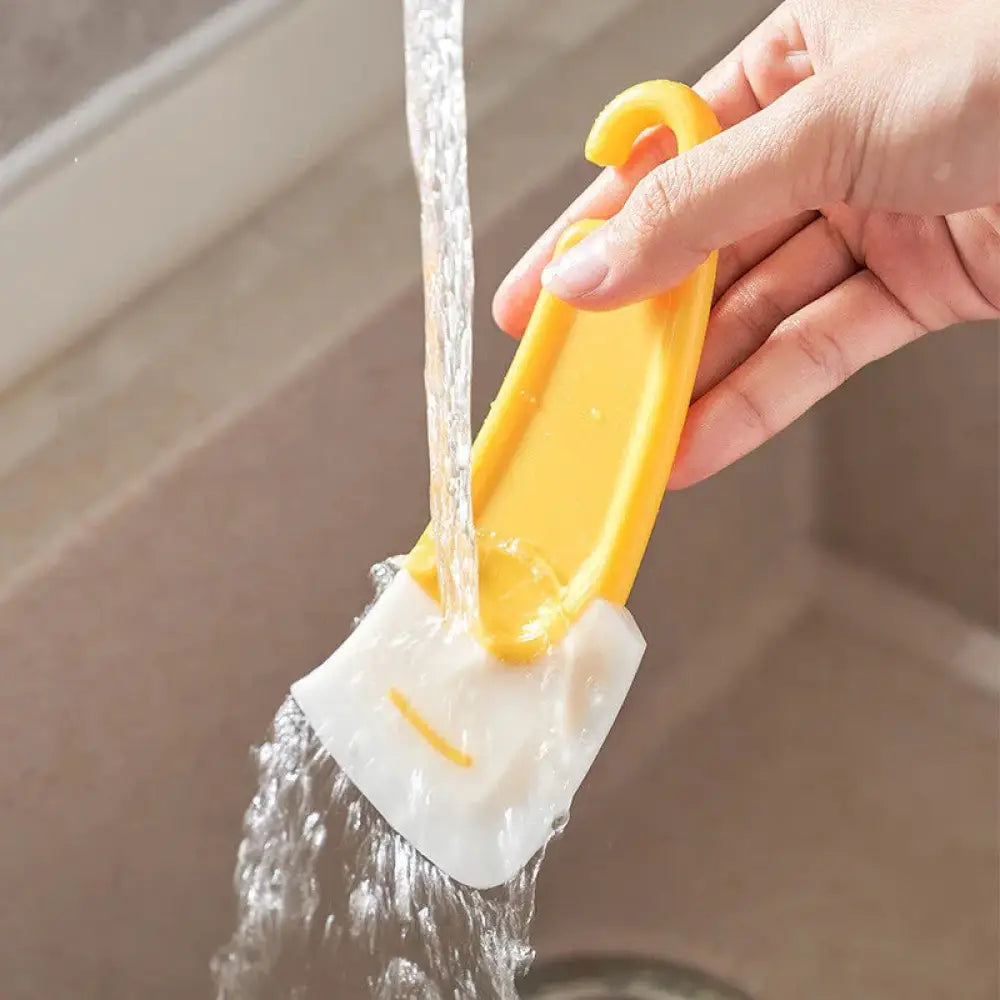 Yellow and white silicone kitchen squeegee and grease scrub brush with smiley face design for efficient cleaning
