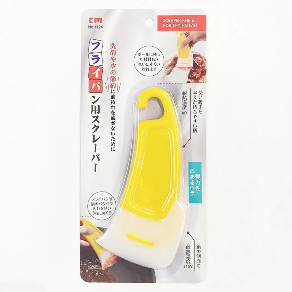 Yellow and white plastic scraper knife for frying pans in retail blister pack with japanese text for kitchen use