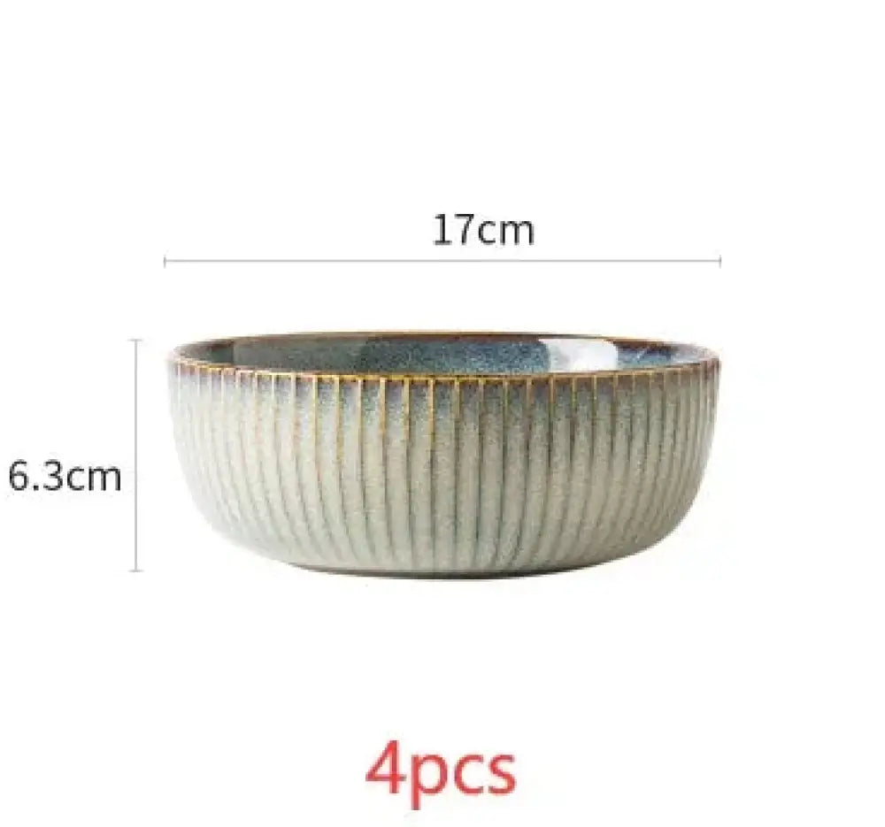 A ceramic Nordic dinnerware bowl with vertical ridges and gradient glaze from light gray to dark blue at the rim