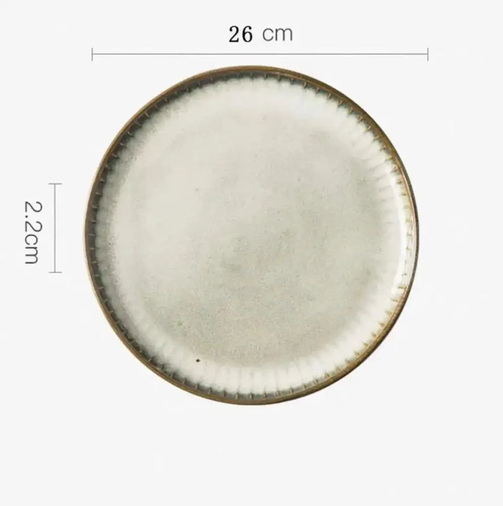 A 26 cm wide ceramic plate with a matte off-white glaze and textured earth-toned rim from the Nordic ceramic dinnerware set