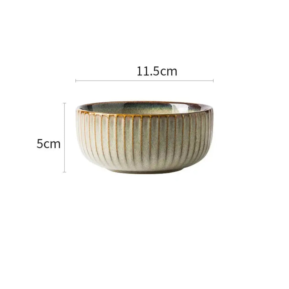 A ceramic bowl with vertical ridges in muted beige exterior and dark greenish-blue glazed interior from the nordic ceramic dinnerware set