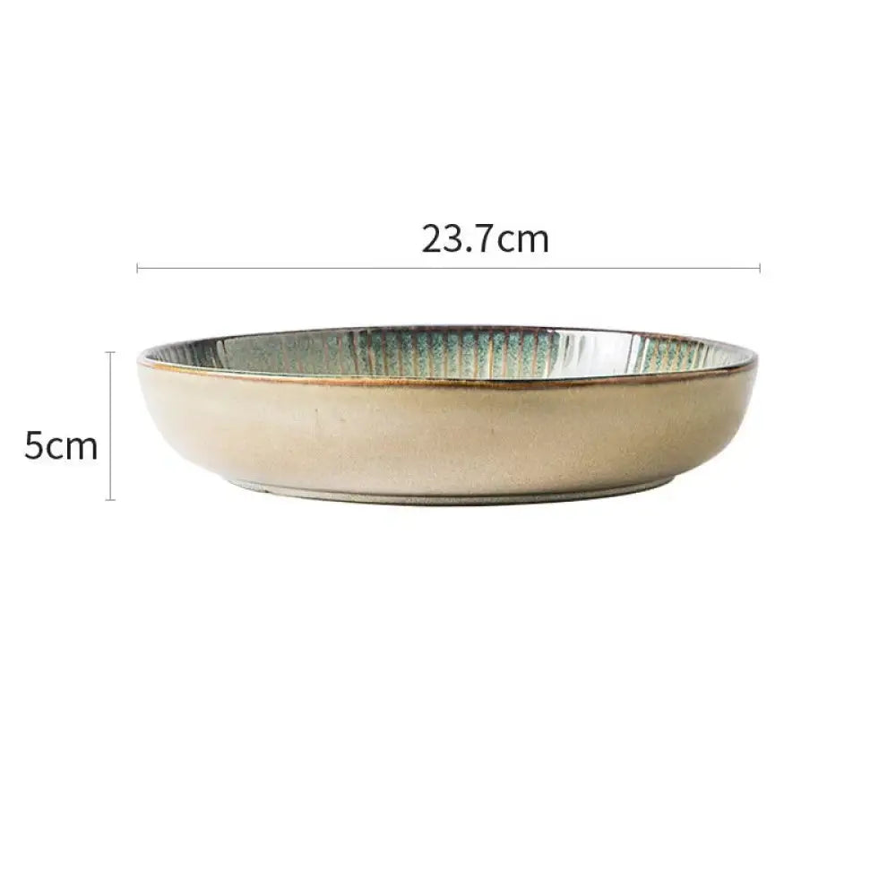 Ceramic bowl from the nordic ceramic dinnerware set with a beige exterior and textured iridescent green interior glaze