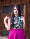 A hummingbird print vintage bow top sleeveless 100% cotton blouse with vibrant floral embroidery in pink, purple, green, and white
