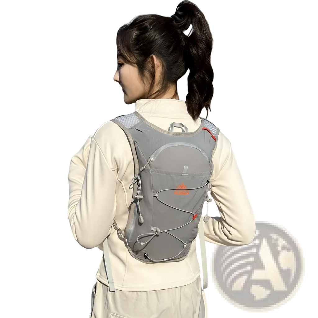 Gray hydration backpack lightweight running vest with orange accents and mesh back panel shown from the back side