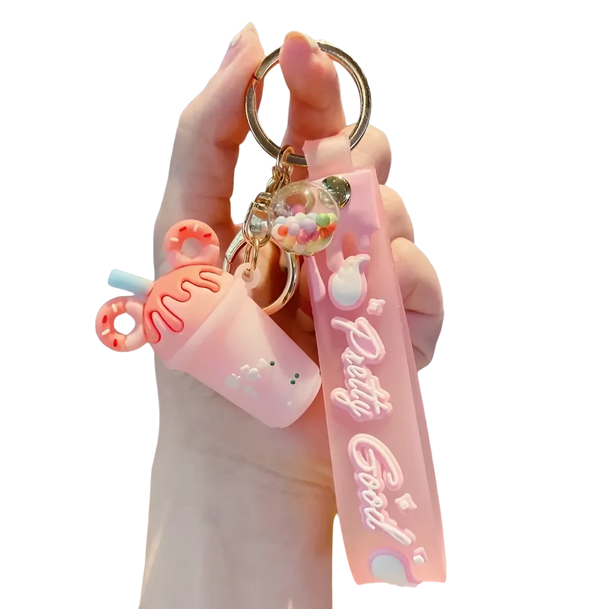 Pink silicone ice cream keychain with cute sprinkle drink and donut charm attached to matching strap with pretty good text