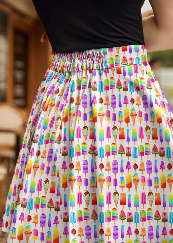 A vibrant white cotton skater skirt with a playful rainbow ice cream popsicle and cone print