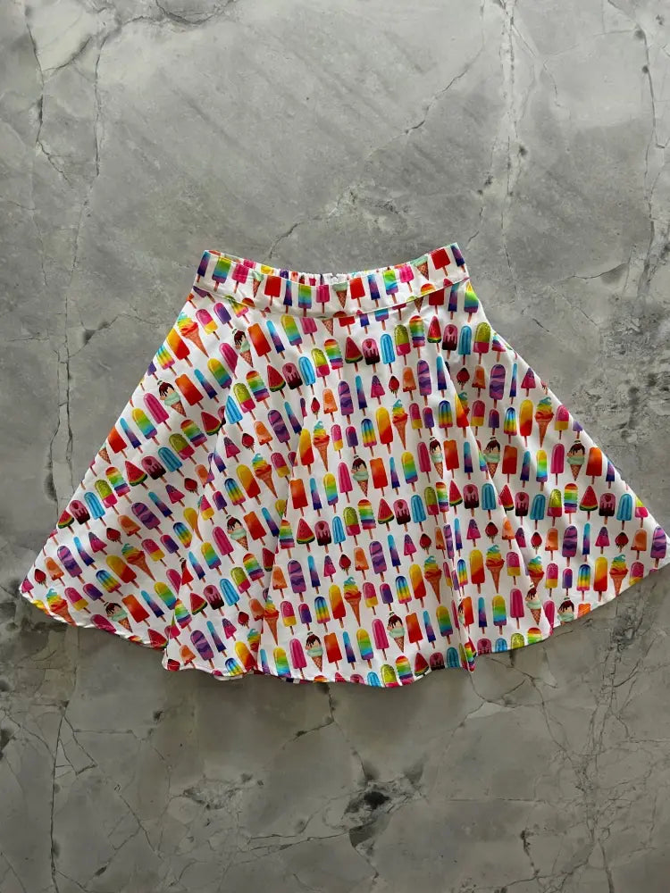 White cotton skater skirt with a vibrant rainbow ice cream and popsicle print in a flared design