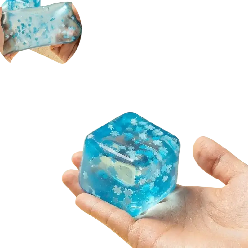 Blue translucent gel ice cubes with white snowflake patterns designed as slow rising sensory fidget toy ice cubes