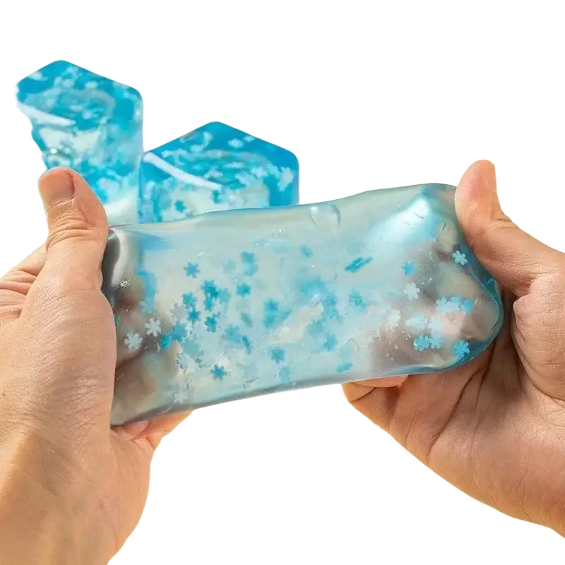 Blue translucent gel ice cubes slow rising squishy sensory fidget toy with embedded snowflake particles