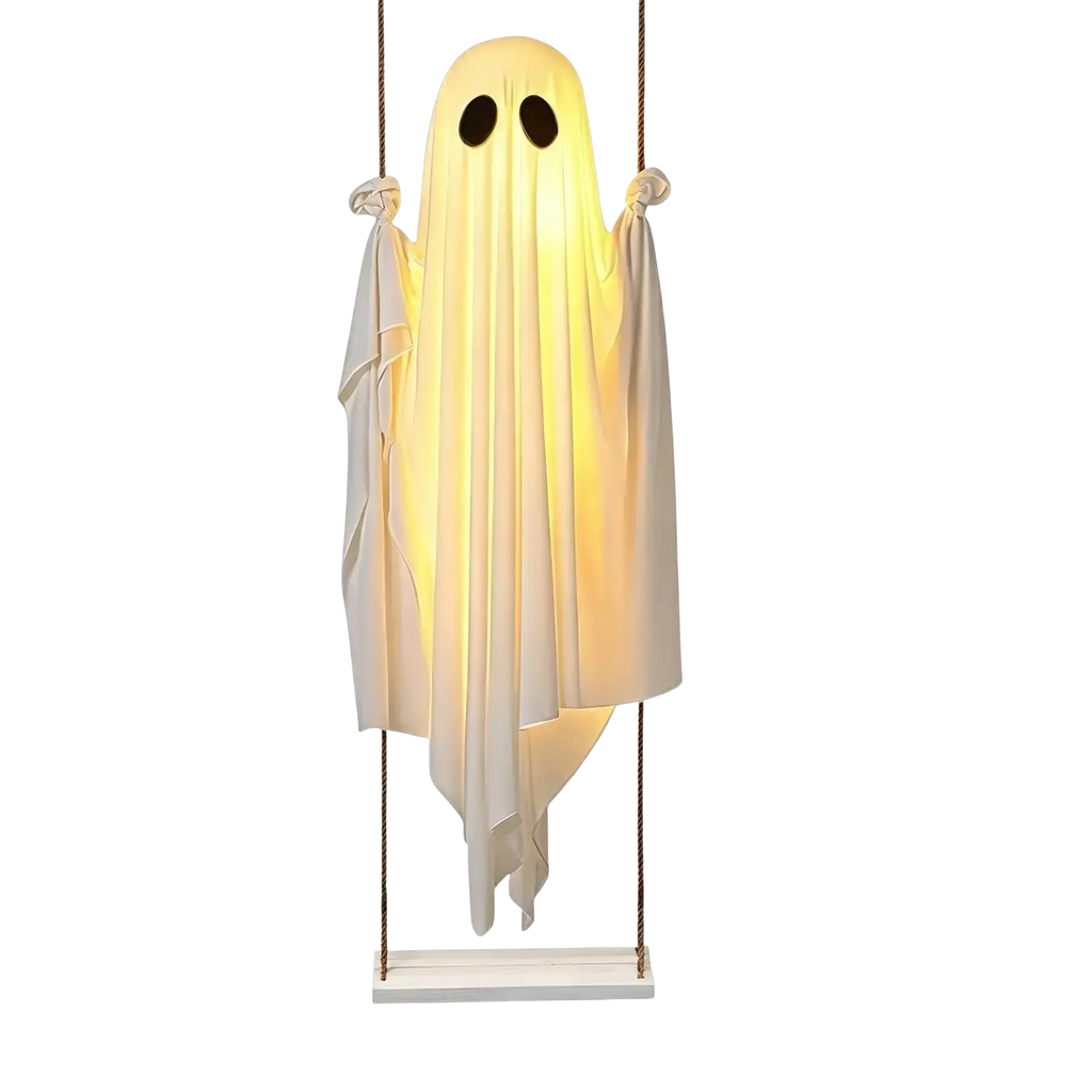 Glowing white swinging ghost decor with black eye cutouts made of fabric hanging from wooden base for outdoor halloween