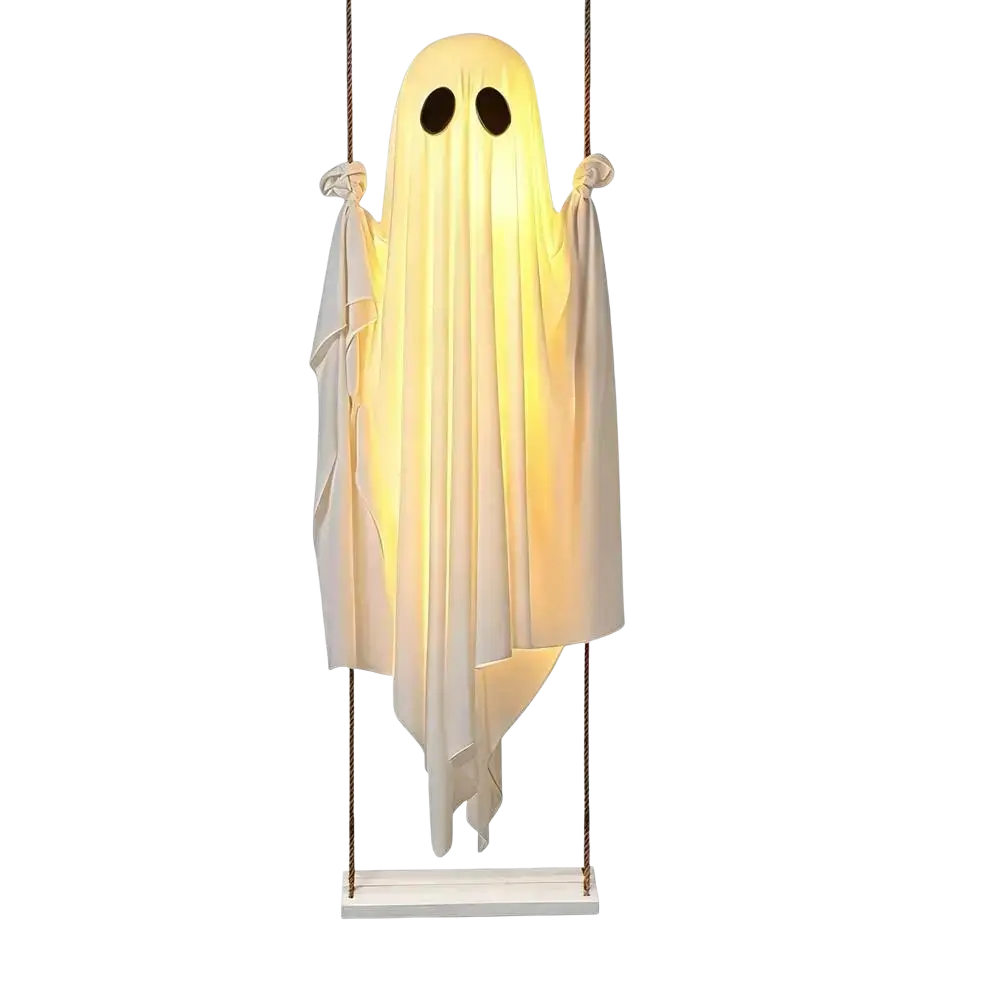 A glowing white swinging ghost decor with flowing translucent fabric and black eyes for outdoor Halloween use