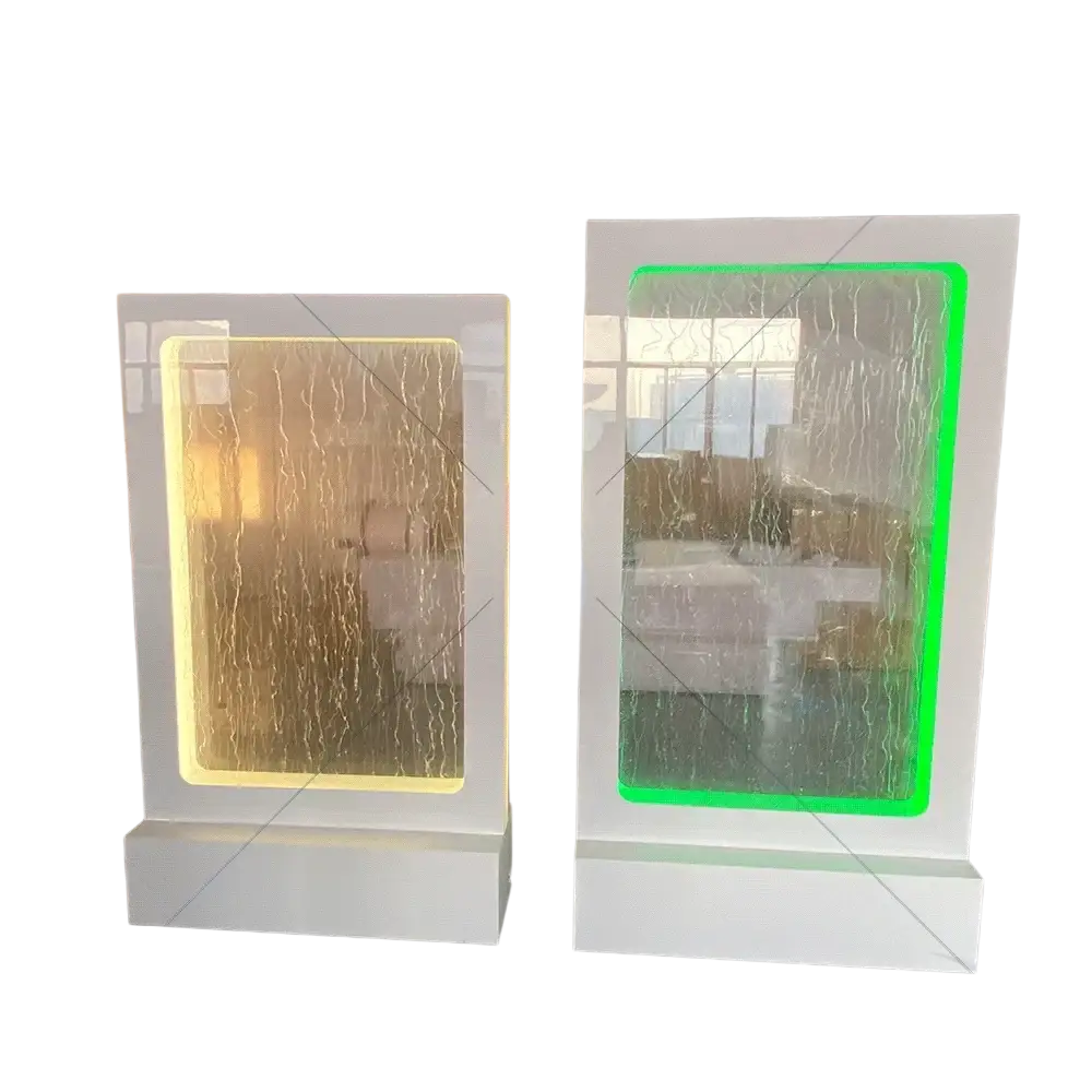 Two illuminated wedding water fountain backdrop sign panels with warm yellow and vibrant green glass waterfall effects in white frames