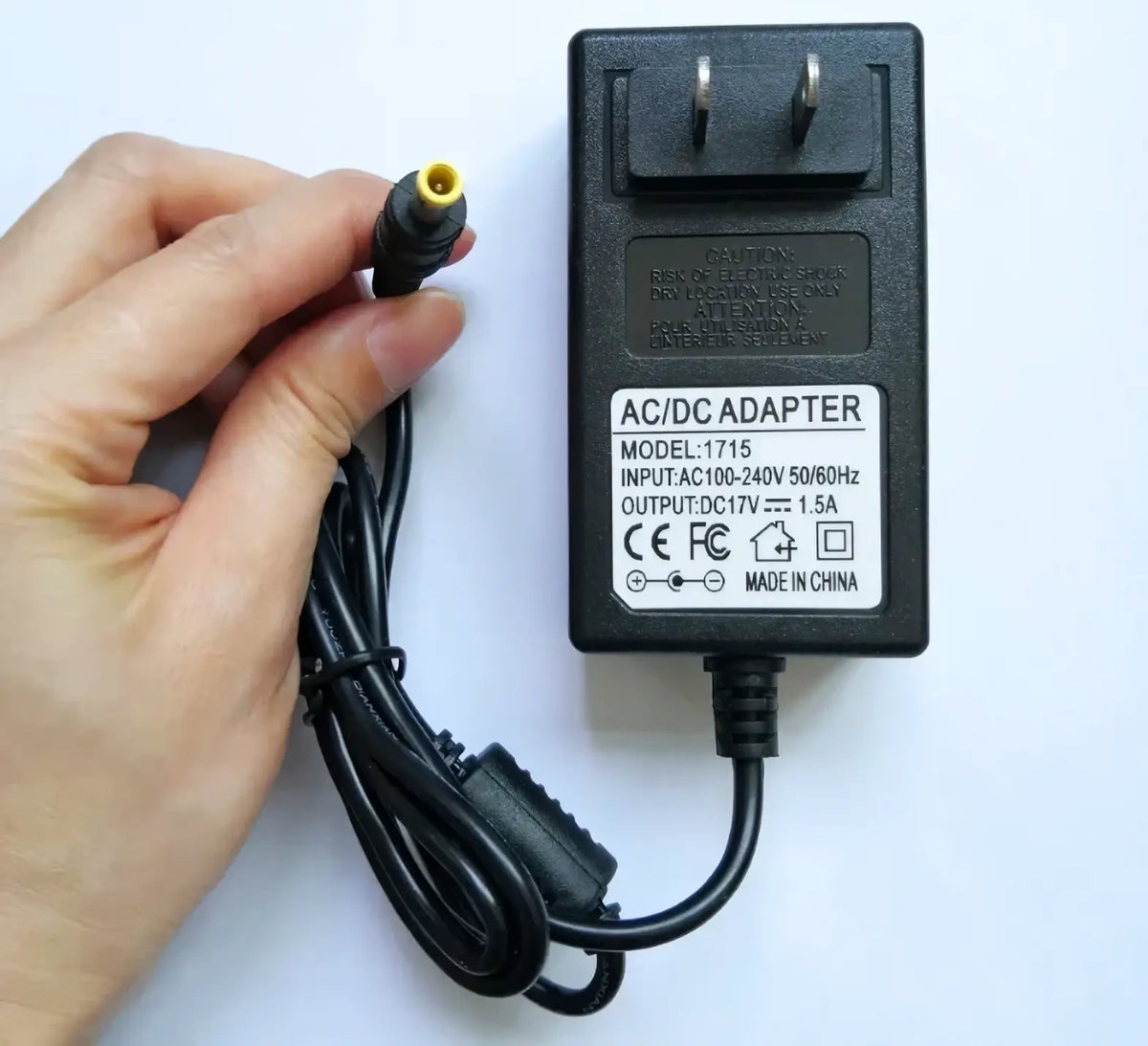 Black plastic ac dc adapter ilsintech swift kf4a with model 1715 yellow-tipped dc plug and coiled power cord