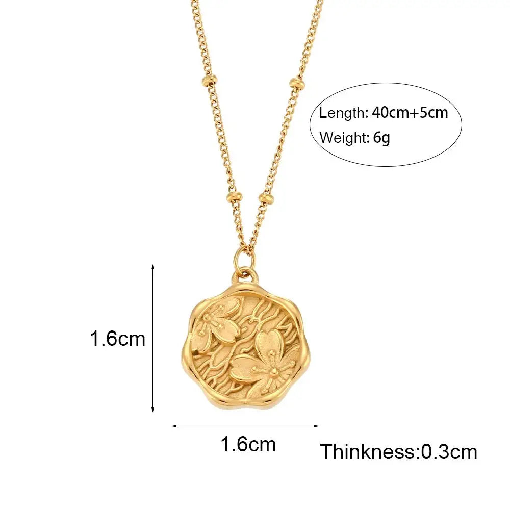 Gold-toned hexagonal necklace pendant with embossed floral design engraved in the garden gold floral pendant necklace