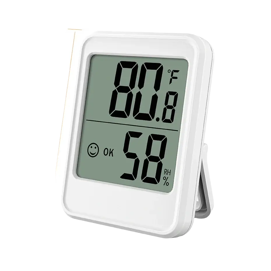 White rectangular indoor digital temperature humidity meter with stand showing 80.8f and 58 rh with smiling face icon