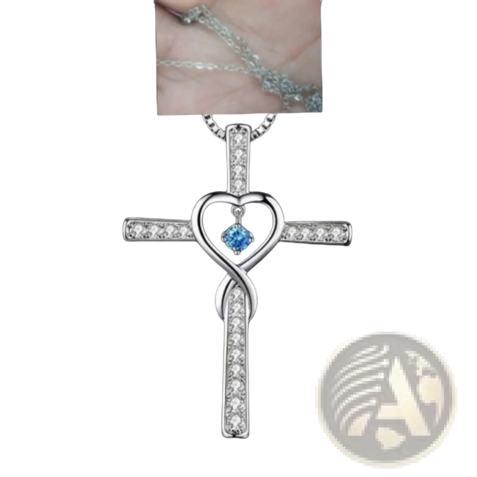 Silver cross pendant necklace with heart-shaped center blue gemstone and clear crystals along its arms