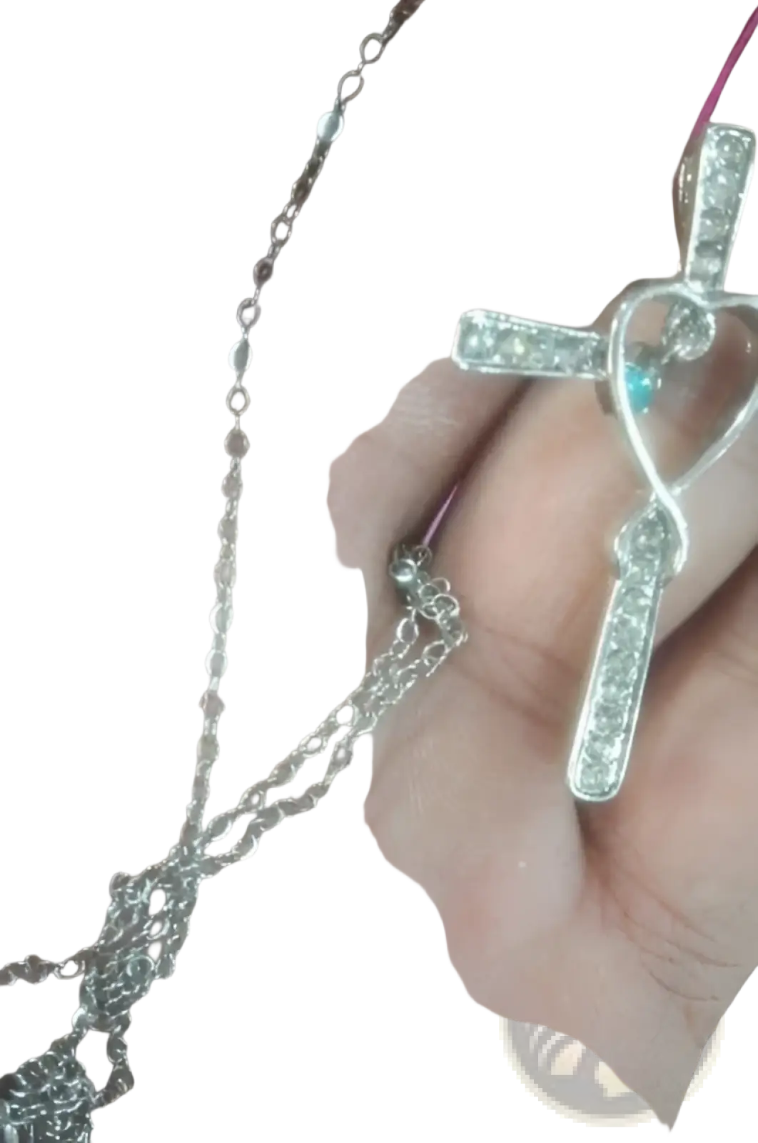 Silver cross pendant with heart-shaped infinity loop design, clear cubic zirconia stones, and a turquoise accent birthstone