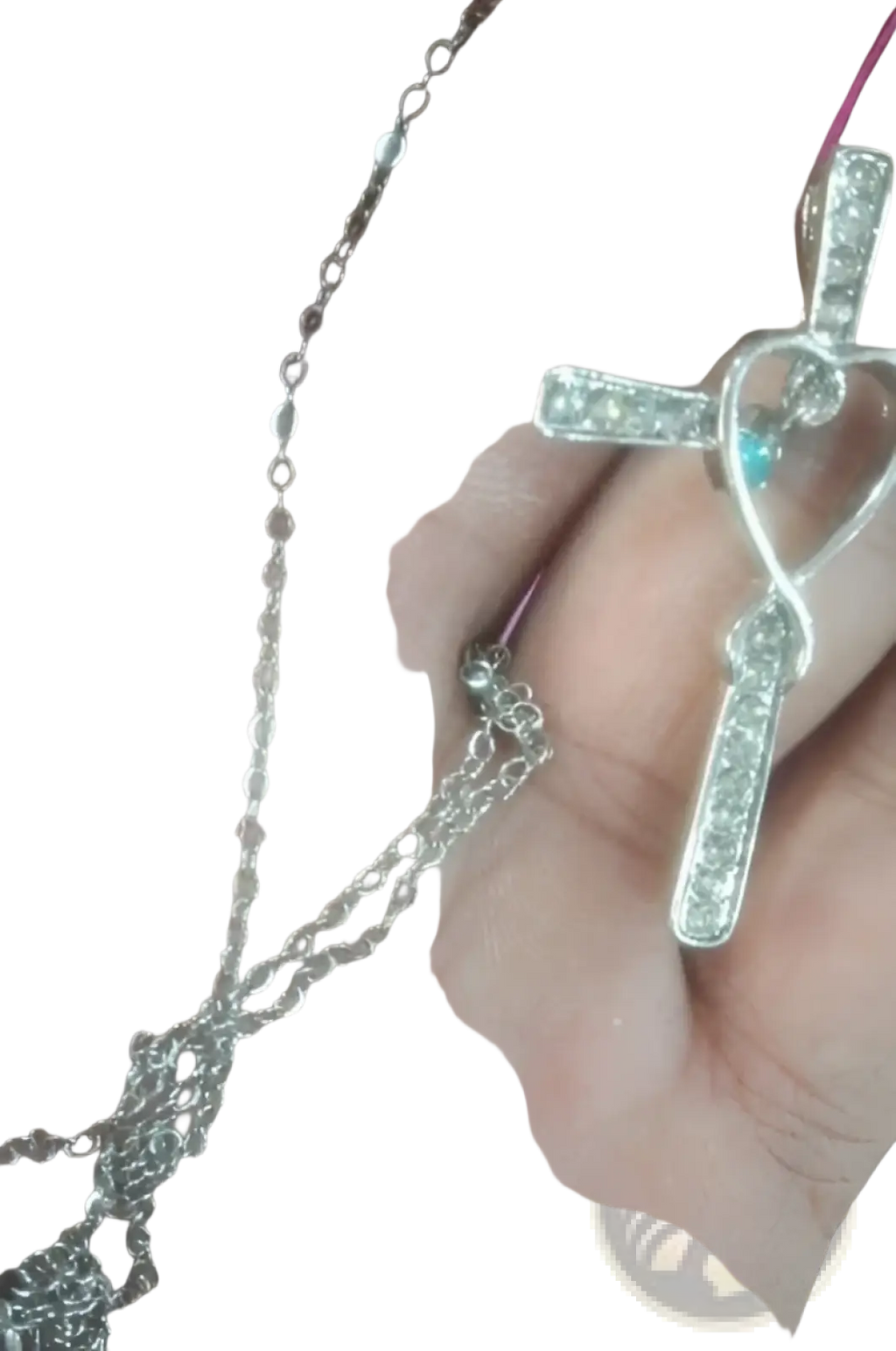 Silver cross pendant with heart-shaped infinity loop design adorned with clear cubic zirconia and turquoise stone