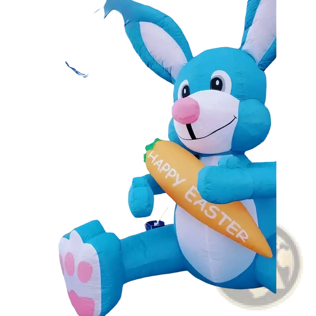 A cheerful blue inflatable Easter bunny with white accents holding a yellow carrot reading happy Easter party decoration