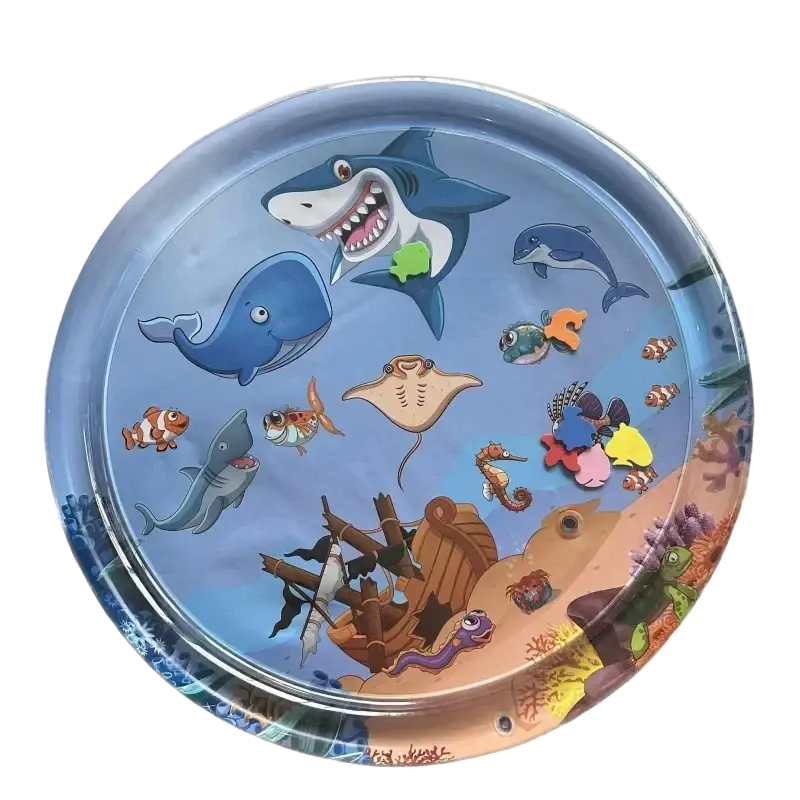 Circular inflatable water mat with a colorful ocean scene featuring cartoon sharks whales fish and an underwater shipwreck