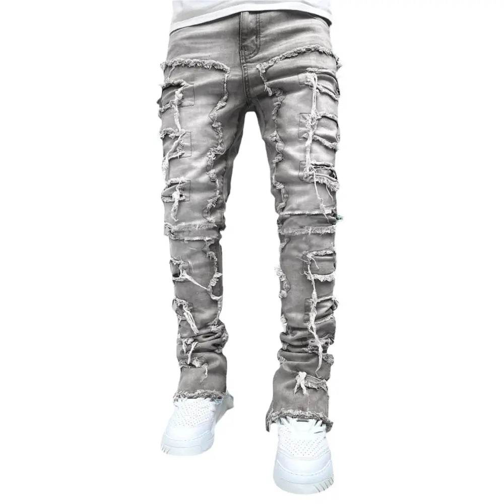 Men’s slim fit gray distressed denim jeans with multiple ripped and frayed patches for streetwear style
