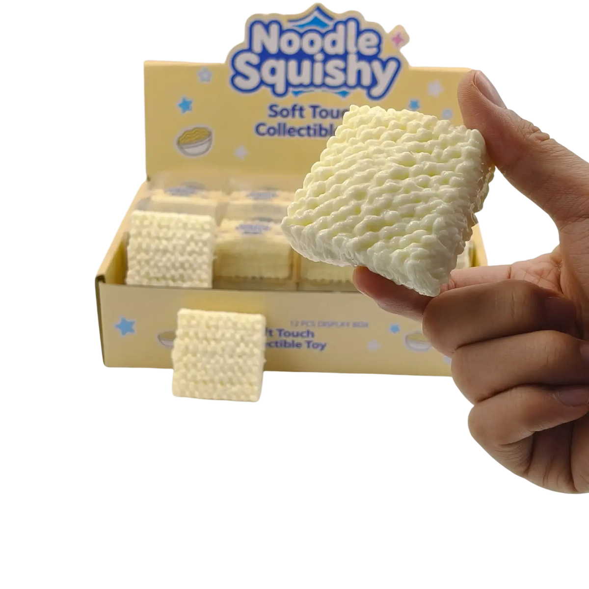 A creamy white knitted textured instant noodle squishy toy held in hand for stress relief and collectible use