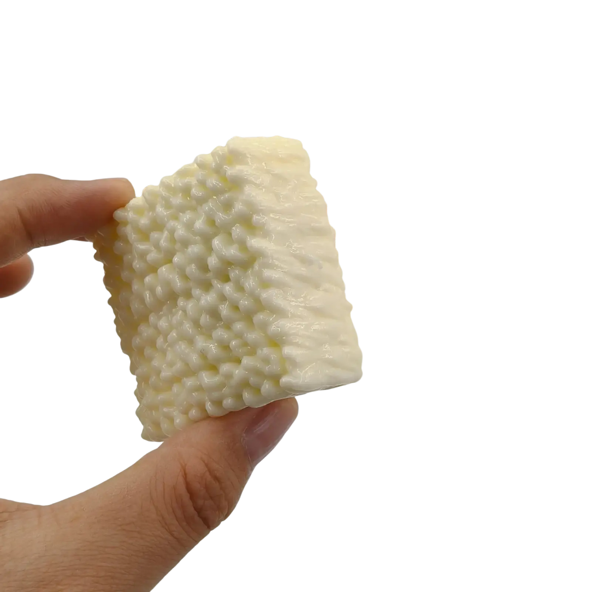 A creamy white instant noodle squishy toy with textured knitted-like surface for stress relief and building block play