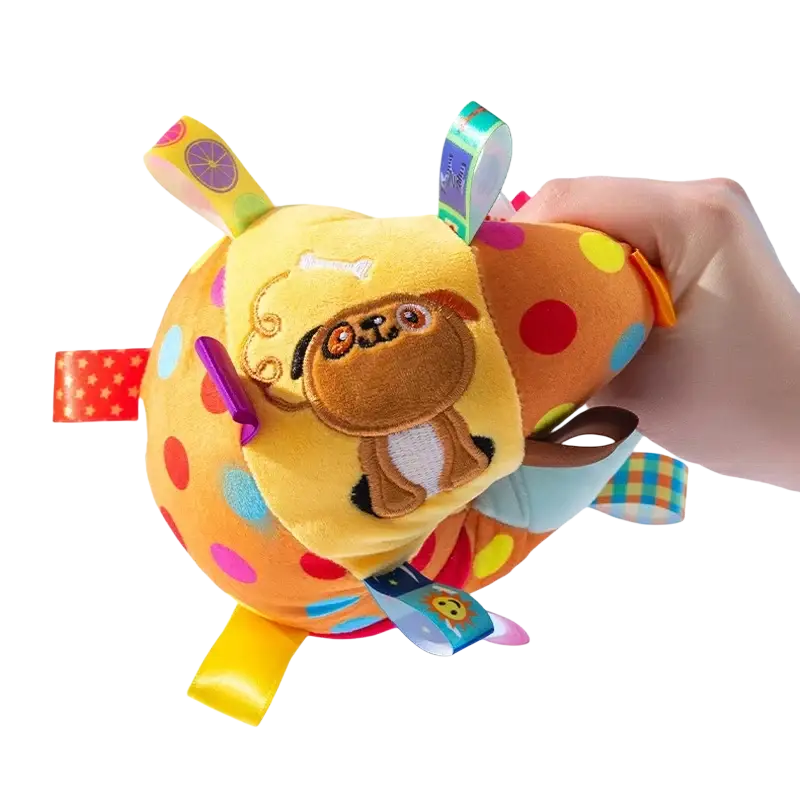 Bright yellow and orange plush interactive ball dog toy with colorful polka dots and attached fabric handle tags