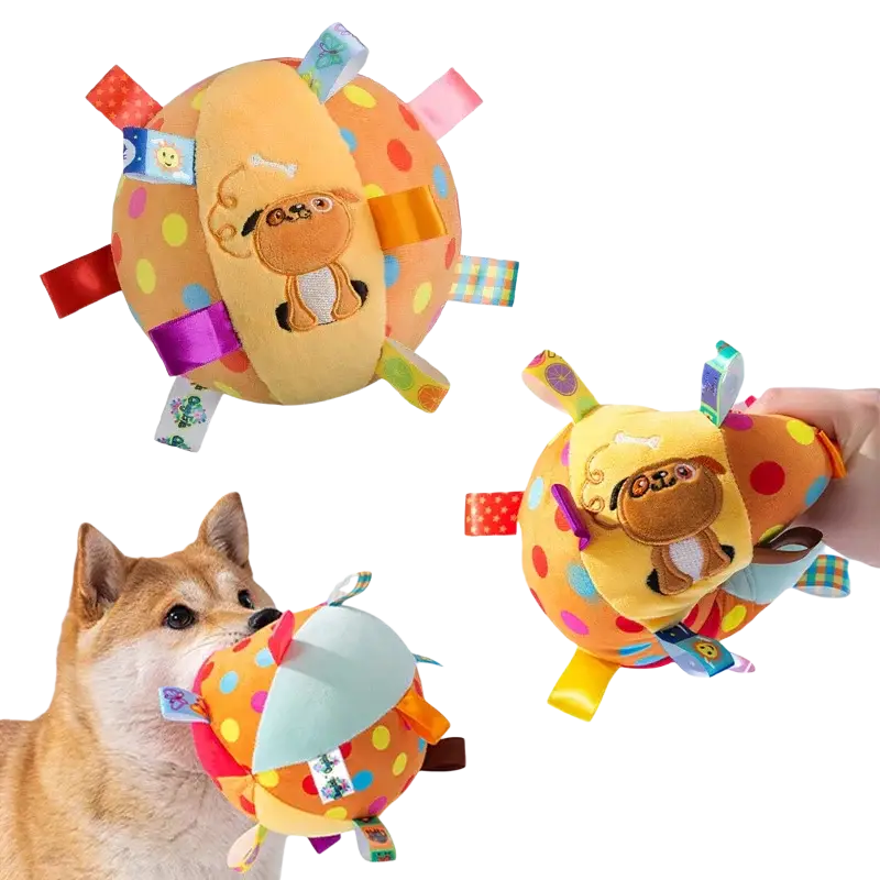 Interactive ball dog toy featuring a soft orange polka-dotted plush ball with a stitched pug face and colorful fabric tags