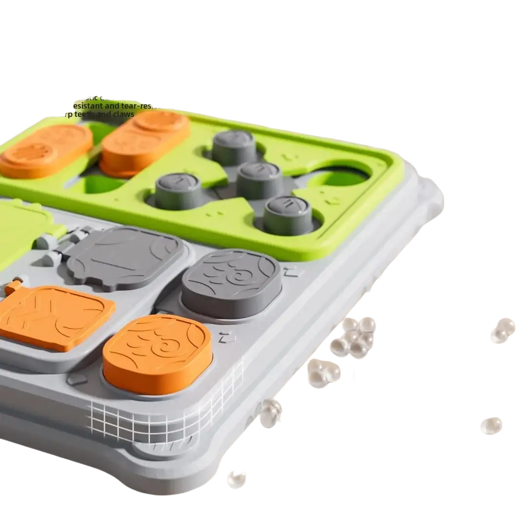 Bright green and gray plastic interactive dog puzzle feeder toy with orange and gray puzzle-like food dispensers