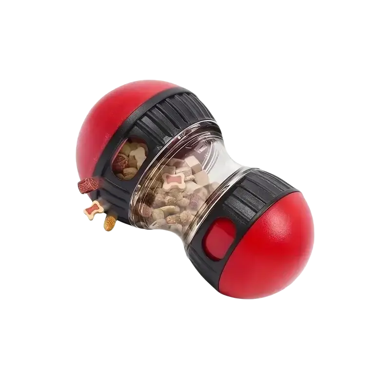 Interactive dog treat dispenser slow feeder toy in red and black plastic with clear section filled with bone-shaped kibble