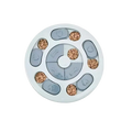 White circular slow feeder dog toy with gray heart and bone lids holding kibble for interactive educational feeding