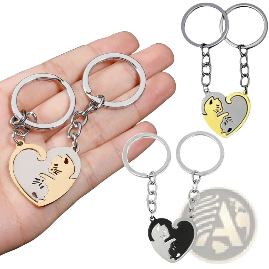 Heart-shaped keychains featuring two interlocking cat designs in gold and silver black in an interlocking cat couple keychain set