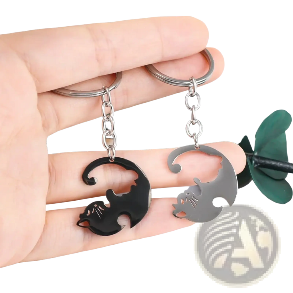 A pair of sleek minimalist interlocking cat couple keychains in black and silver metallic finishes