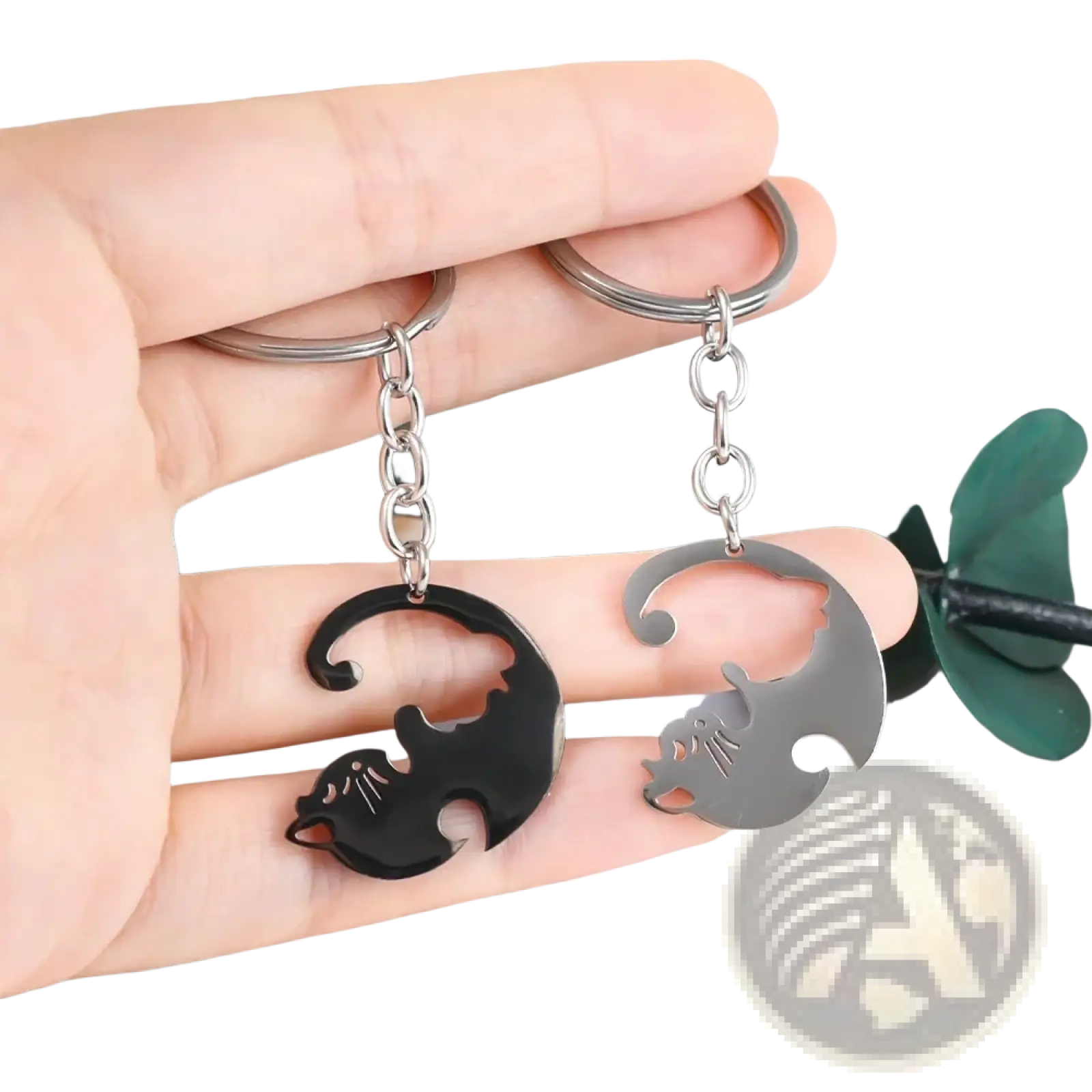A pair of sleek minimalist interlocking cat couple keychains in black and silver metallic finishes