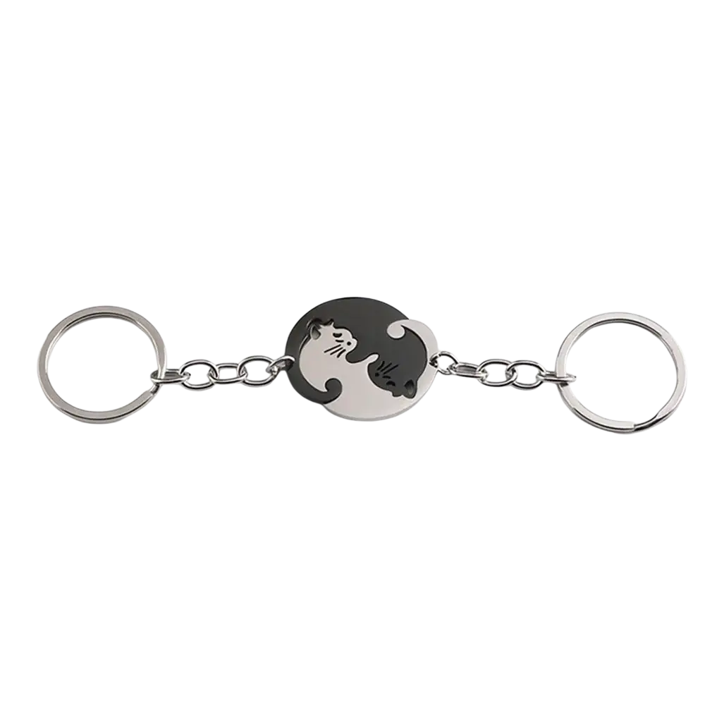 Silver-toned interlocking cat couple keychain set with circular yin-yang medallion featuring black and white cats