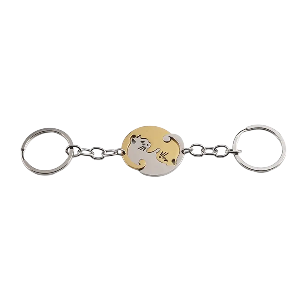 A sleek two-toned metallic interlocking cat couple keychain set featuring gold and silver circular silhouettes