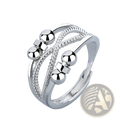 Silver adjustable interwoven ring with three textured bands featuring polished spherical beads for anxiety relief