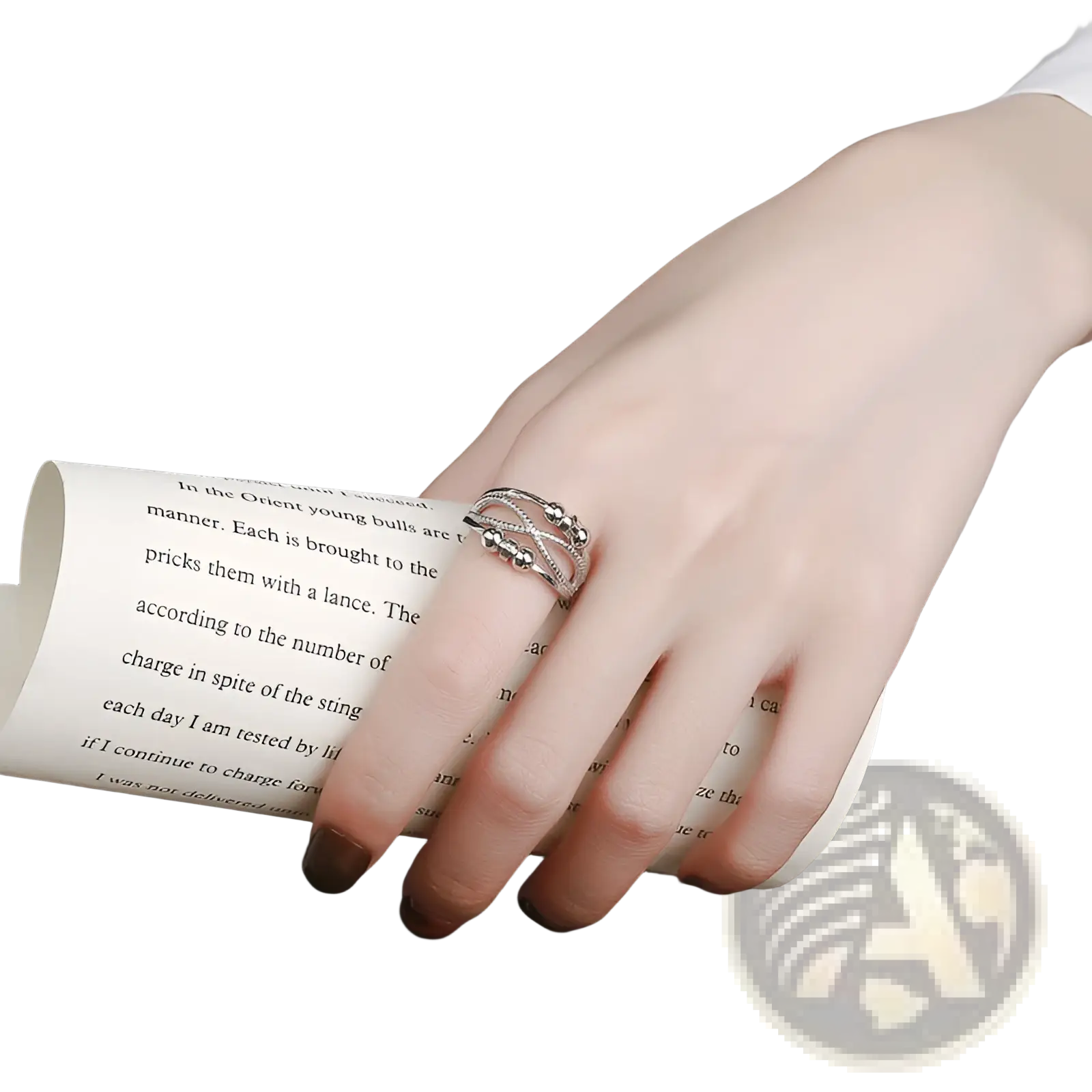 A delicate silver interwoven anxiety relief adjustable ring with small spherical accents adorning the finger