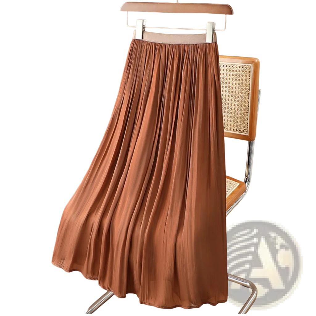 A flowing rust-colored iridescent chiffon pleated midi skirt with soft lightweight fabric hanging on a wooden hanger