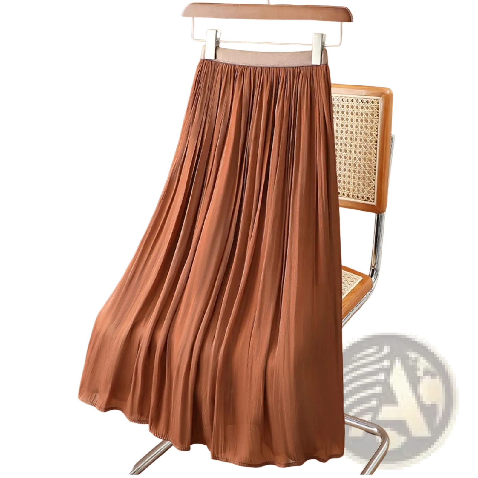 A flowing rust-colored iridescent chiffon pleated midi skirt with soft lightweight fabric hanging on a wooden hanger