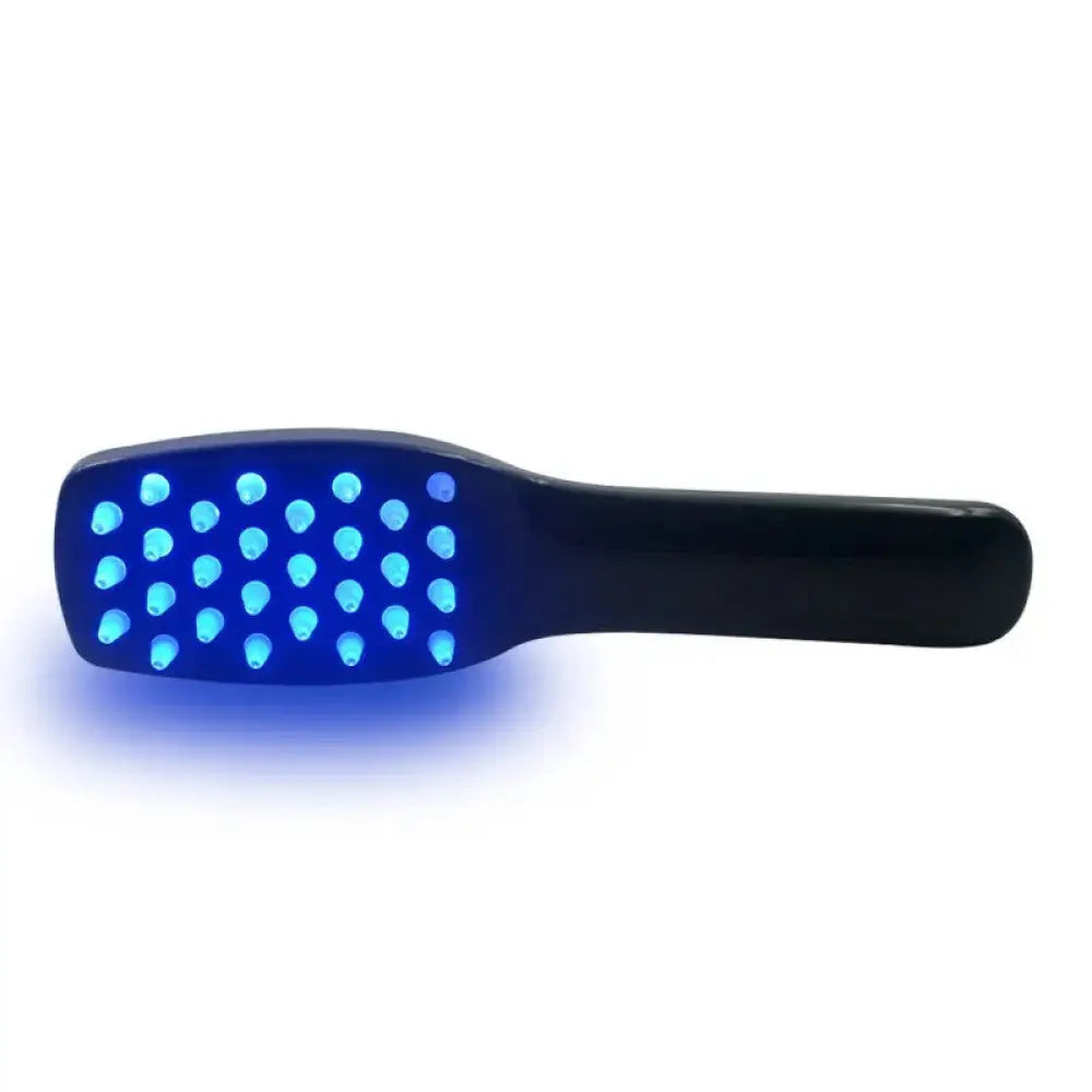 Black handheld LED hair treatment brush with glowing blue phototherapy lights for scalp and hair massage therapy