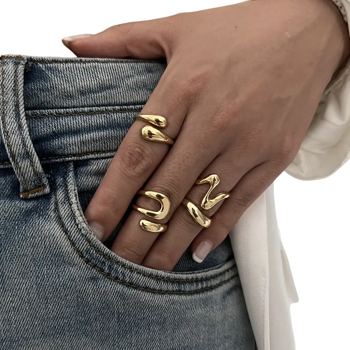 Gold-toned irregular geometric ring set with abstract design worn on fingers featuring a sleek modern punk fashion style