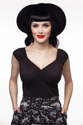 Black wide-brimmed hat with a sleek structured crown and soft curved brim paired with isabel retro black sweetheart neckline top