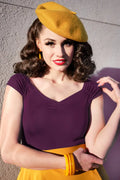 Yellow beret with soft felt texture and small button shown with isabel sweetheart neckline knit top in plum