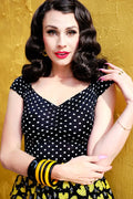 Isabel plus size polka dot sweetheart top in black and white with ruched neckline and yellow leaf patterned flared skirt